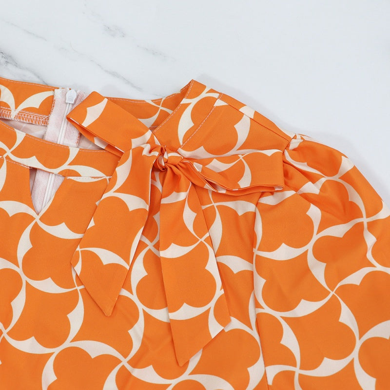 Trendiges orangefarbenes bedrucktes Damenkleid mit 3/4-Ärmeln